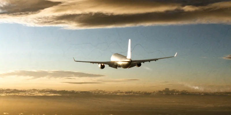 aviation emissions concept with airliner contrail at golden hour