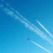 Aircraft contrails crossing a deep blue sky