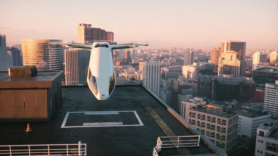 evtol air taxi hovering above a rooftop vertiport at golden hour